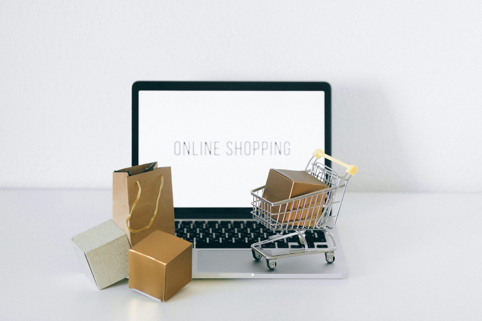 An entrepreneur reviewing sales charts on a laptop displaying high-value products in an online store.