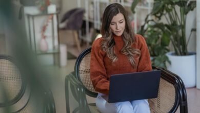 Illustration of a person using Mailchimp for email marketing in 2025, featuring a laptop screen with campaign setup and analytics.