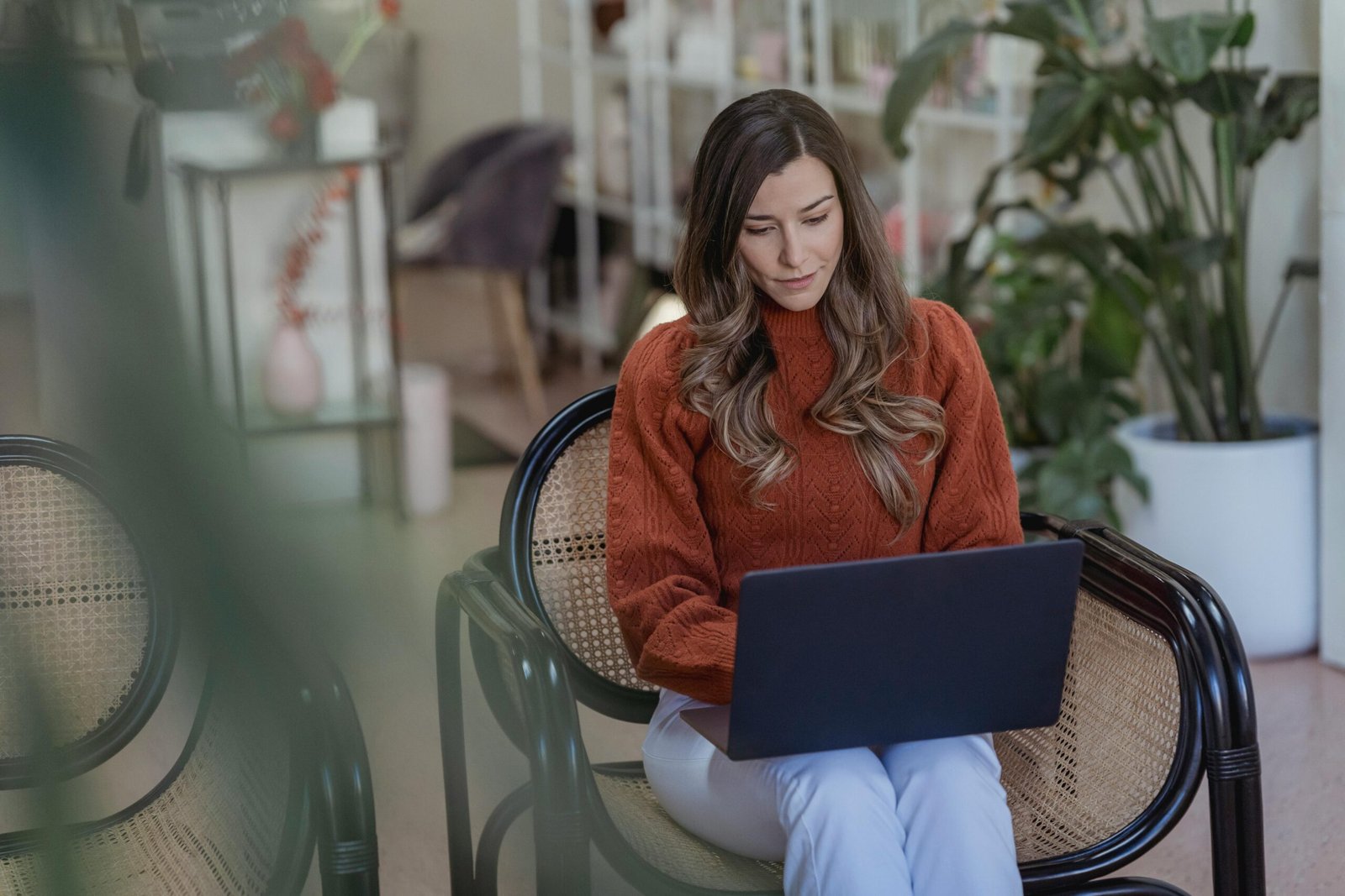 Illustration of a person using Mailchimp for email marketing in 2025, featuring a laptop screen with campaign setup and analytics.