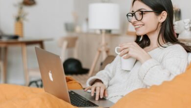 Graphic of a person managing Amazon dropshipping orders using a laptop in 2024, with product listings displayed.